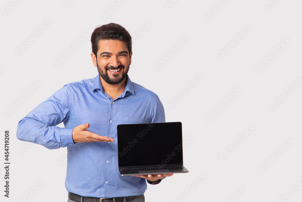 Portrait of a man in formal clothing showing the laptop in his hand.