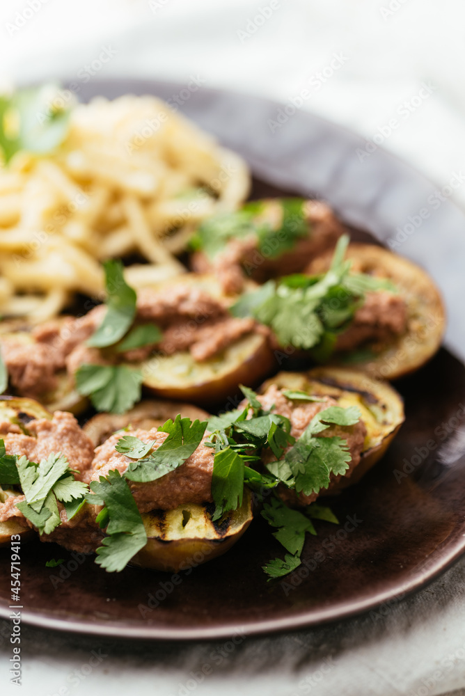 Plate with grilled eggplant slices served with a walnut sauce