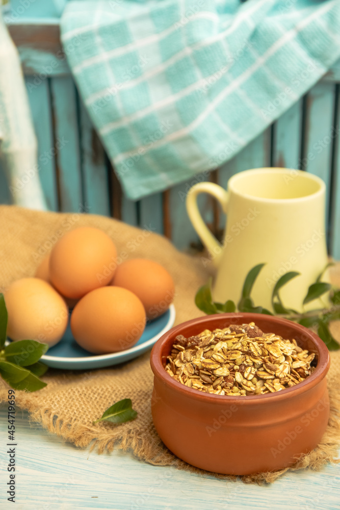 Fototapeta premium Granola and eggs on rural rustic background, healthy eating, wellbeing, healthy lifestyle, breakfast in the morning
