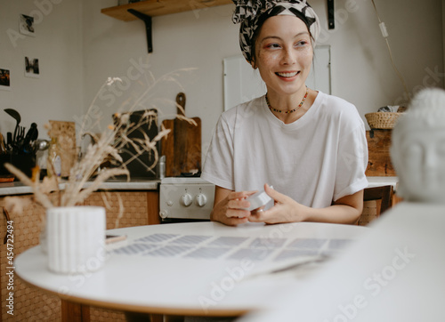 woman with tarot cards on the white kitchen