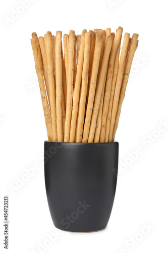 Delicious grissini sticks in cup on white background
