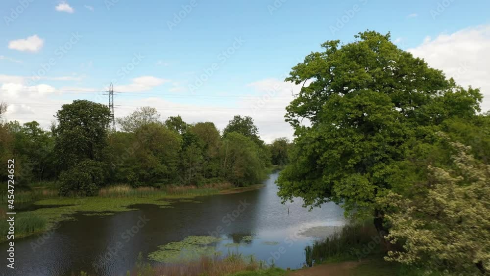 water surface in nature. Revealing bank with pathway. High voltage power line in background water surface in nature. Revealing bank with pathway. High voltage power line in background