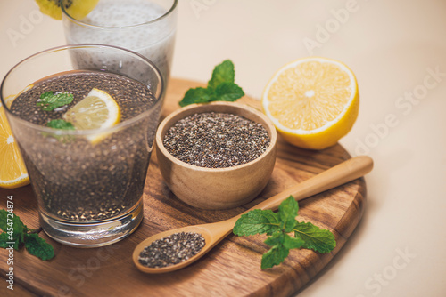 Selective focus of chia seeds drink with water in transparent glass with lemon balm.