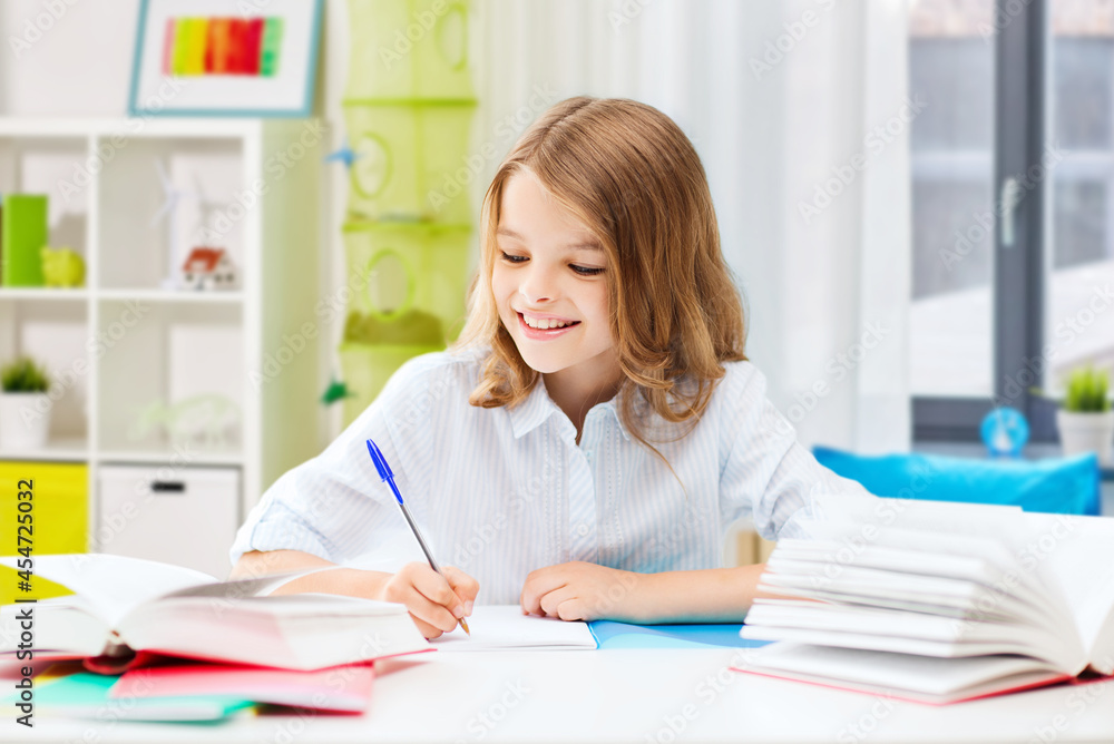 education and school concept - happy smiling student girl with books learning over home room background education and school concept - happy smiling student girl with books learning over home room background