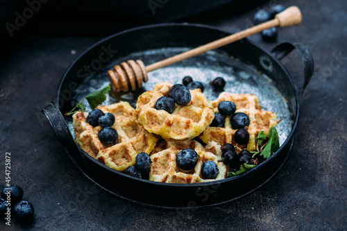 Belgian sweet waffles with blueberries, raspberries and honey