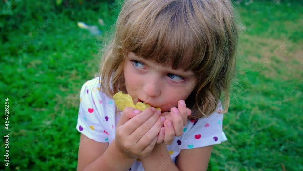 Children eat chips on the street. Selective focus. Children eat chips on the street. Selective focus.