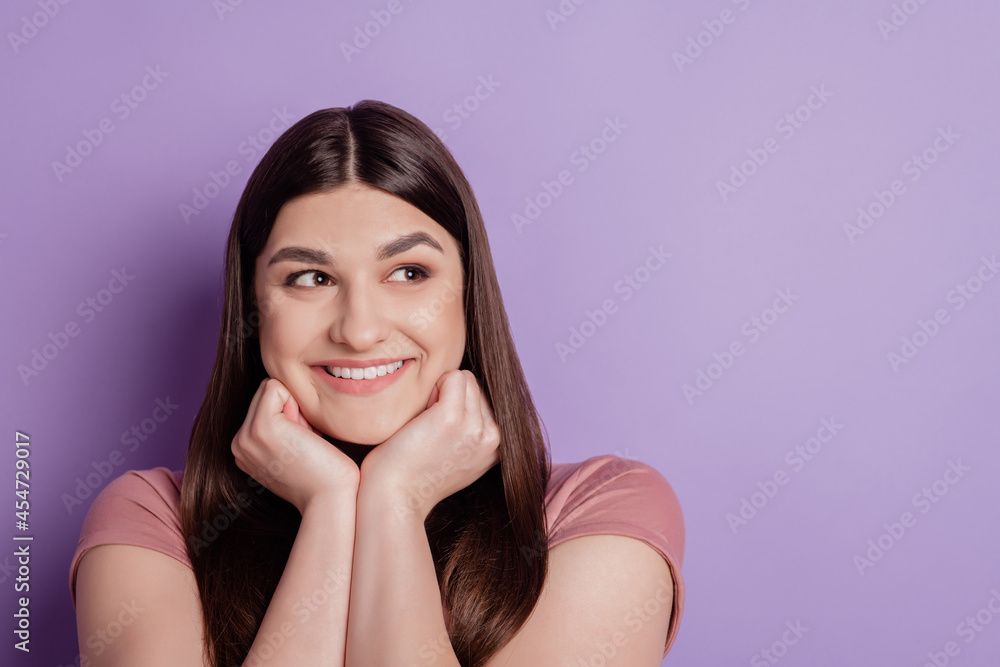 Close up photo of nice attractive girl happy positive smile dream look empty space isolated over violet color background Close up photo of nice attractive girl happy positive smile dream look empty space isolated over violet color background