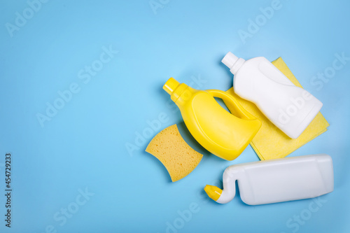 Cleaning supplies on blue background. Top view