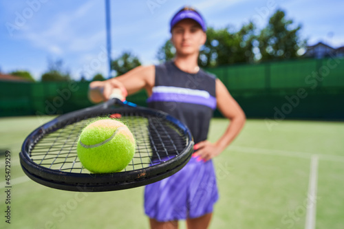 Sportswoman holding tennis racquet while standing on the court © Svitlana