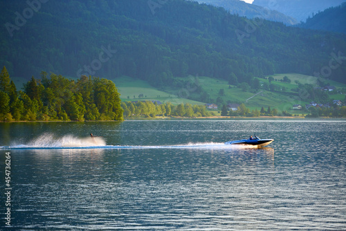 A man on water skis on Lake Wolfgang. Austrian Alps, Salzburg region.