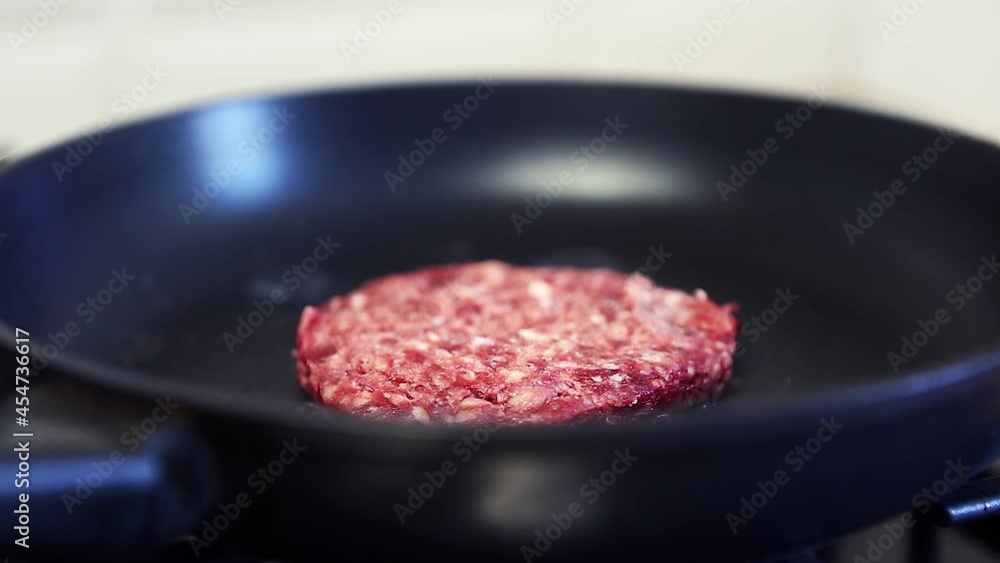 Minced beef meat frying on hot pan in kitchen. Video clip of ground beef cutlet for hamburger being fried in close up Minced beef meat frying on hot pan in kitchen. Video clip of ground beef cutlet for hamburger being fried in close up