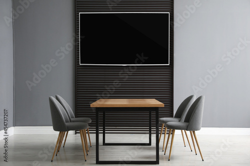Fototapeta Naklejka Na Ścianę i Meble -  Modern wide screen TV on wall in room with stylish furniture