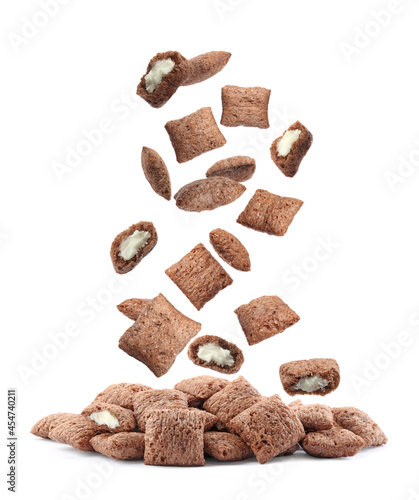 Sweet crispy corn pads falling into pile on white background