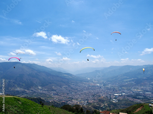 Medellin, Colombia - 20.05.2015: Paragliders flying above Medellin