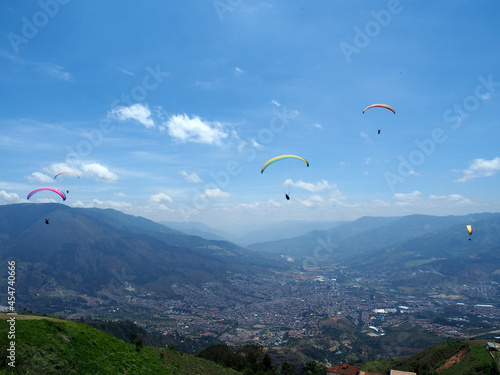 Medellin, Colombia - 20.05.2015: Paragliders flying above Medellin