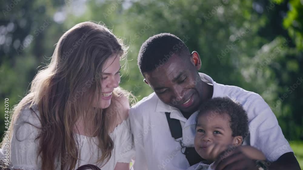Multicultural family in the park. Mom dad and son are having a great time together. Multicultural family in the park. Mom dad and son are having a great time together.