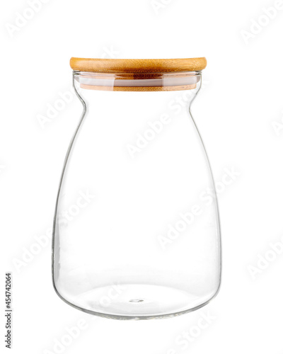 Empty glass kitchen jar with a round wooden cap, composition isolated over the white background