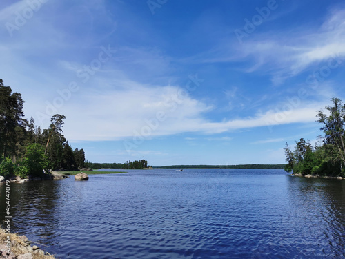 The Strait of Vyborg Bay between the island and the shore in the rocky natural park Monrepos of the city of Vyborg on a clear summer day.
