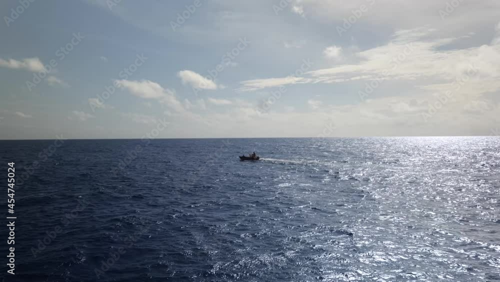 Motorboat driving in sun reflecting on the open ocean in 4k Motorboat driving in sun reflecting on the open ocean in 4k