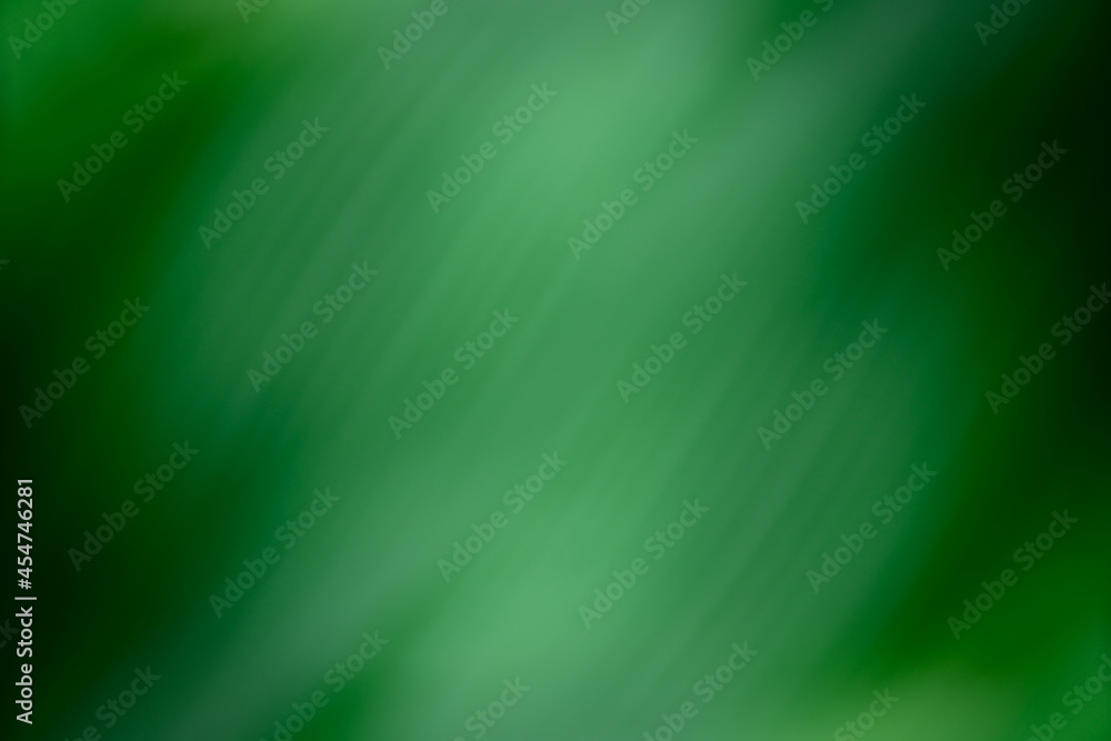 Abstract glowing light on a green blur background texture. Abstract glowing light on a green blur background texture.