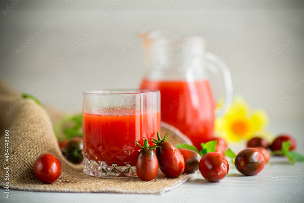 homemade freshly squeezed tomato juice with pulp in a glass decanter