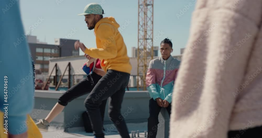 man dancing with friends on rooftop at hip hop dance party performing crazy b boy dance moves with friends cheering man dancing with friends on rooftop at hip hop dance party performing crazy b boy dance moves with friends cheering