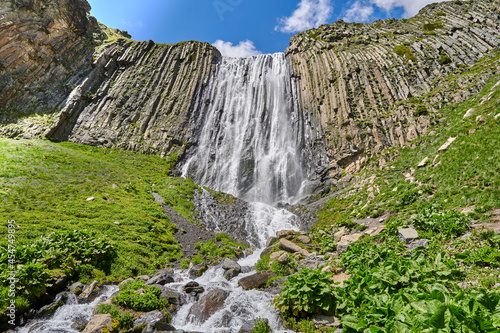 gorge high waterfall Terskol with a mountain river in the Elbrus region