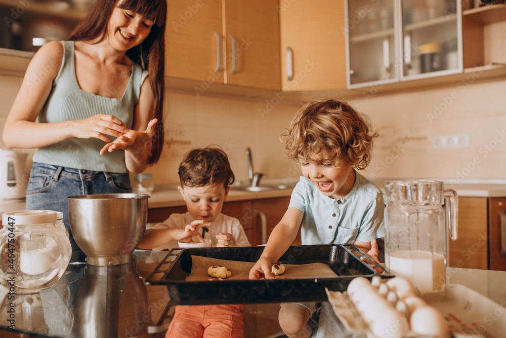 Mother baking cookies with her sons