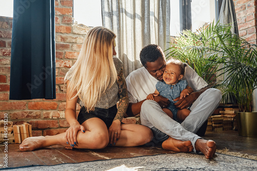 Joyful family of father mother and their daughter together