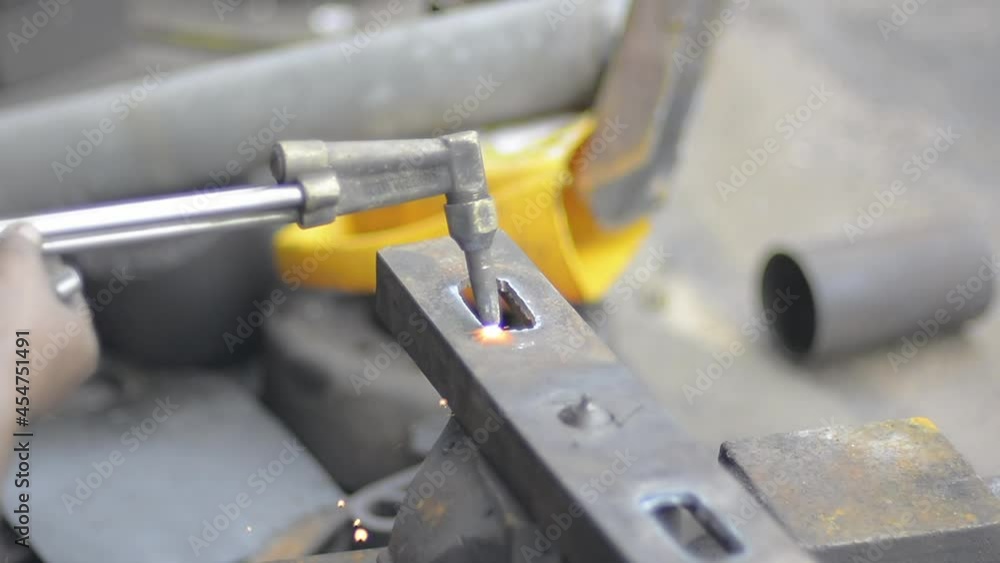 Closeup cutting steel or welding with fire from gas and orange sparks fly Closeup cutting steel or welding with fire from gas and orange sparks fly