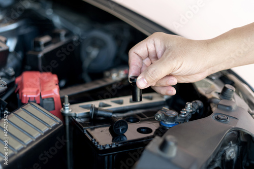 A man open cap of add battery for add distilled : maintenance and inspections for extended service life battery of car
