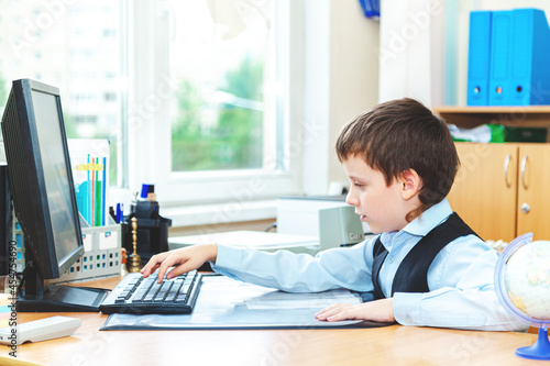 Serious schoolboy in the classroom.