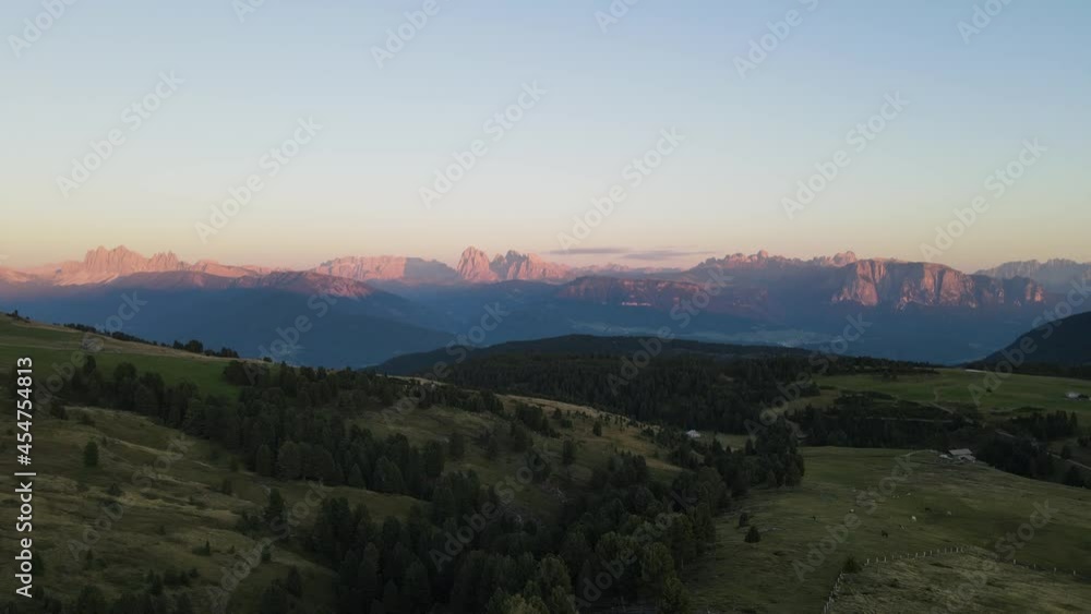 aerial drone shot of the alps while sunset with huts and farmland, beautiful nature. In the middle of the Dolomites. aerial drone shot of the alps while sunset with huts and farmland, beautiful nature. In the middle of the Dolomites.