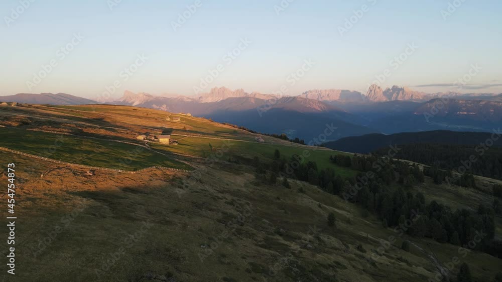 aerial drone shot of the alps while sunset with huts and farmland, beautiful nature. In the middle of the Dolomites. aerial drone shot of the alps while sunset with huts and farmland, beautiful nature. In the middle of the Dolomites.