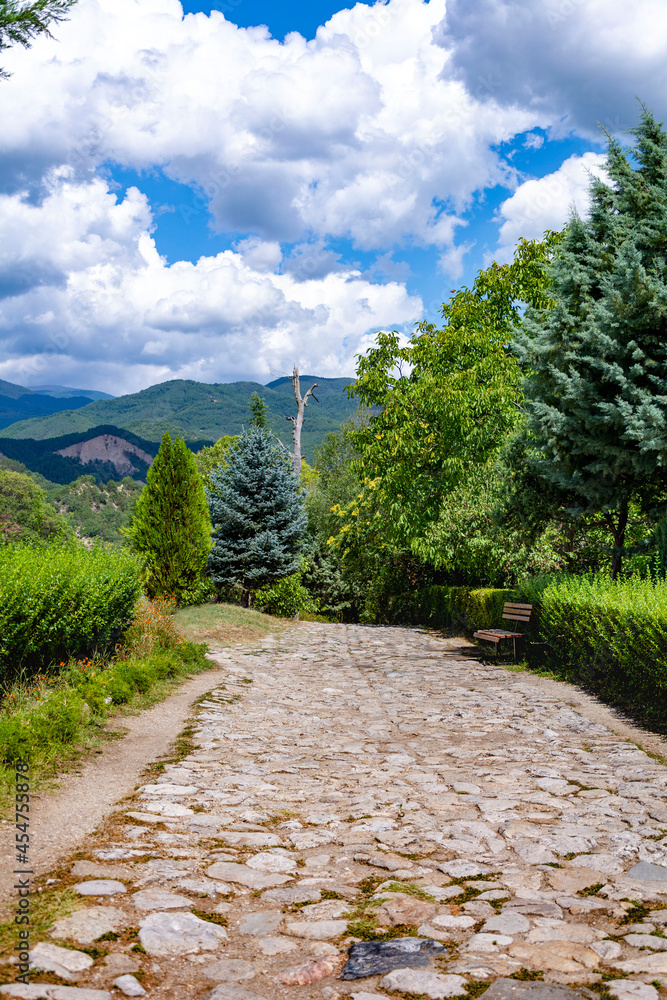 Pavement path in the mountains in sunny summer day