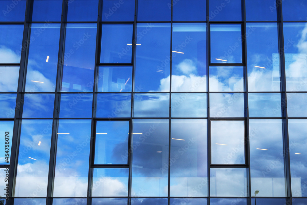Clouds reflecting off the glass facade of a skyscraper. Clouds reflecting off the glass facade of a skyscraper.
