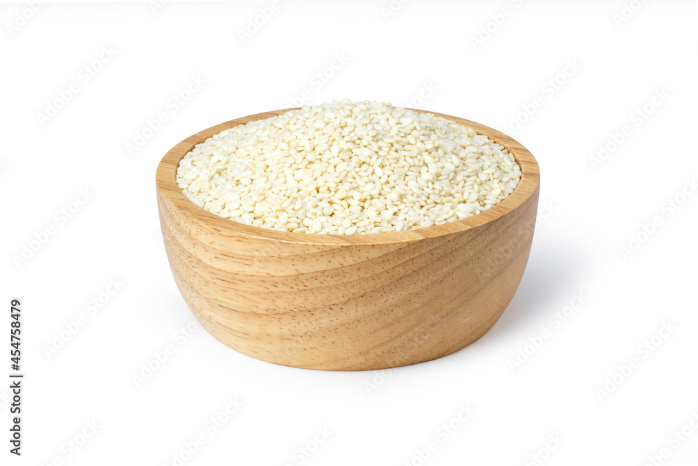 White sesame seeds in wooden bowl isolated on white background. White sesame seeds in wooden bowl isolated on white background.