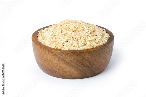 Coarse brown rice in wooden bowl isolated on white background. Clipping path.