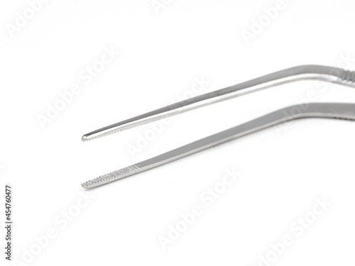 curved steel surgical tweezers with teeth on a white background