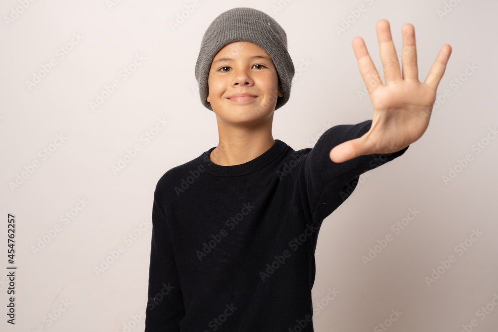 Portrait of a young boy smiling wearing a woolen hat on white background Portrait of a young boy smiling wearing a woolen hat on white background