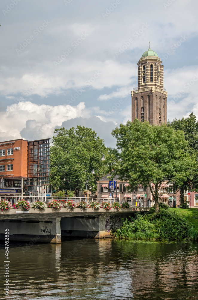 Zwolle, The Netherlands, August 20, 2021: western entrance to the old town with the iconic Peperbus tower rising above the trees and houses