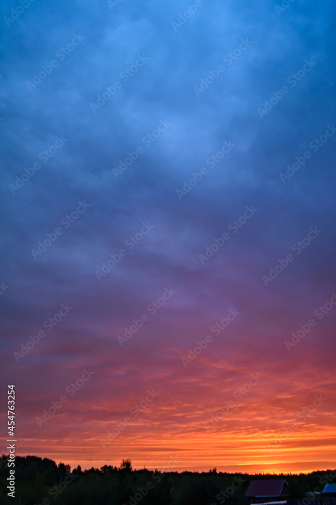 Sunrise turns the clouds pink and red