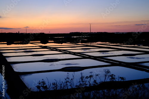 The last sun rays in the salt marshes of Guerande. France summer 2021.