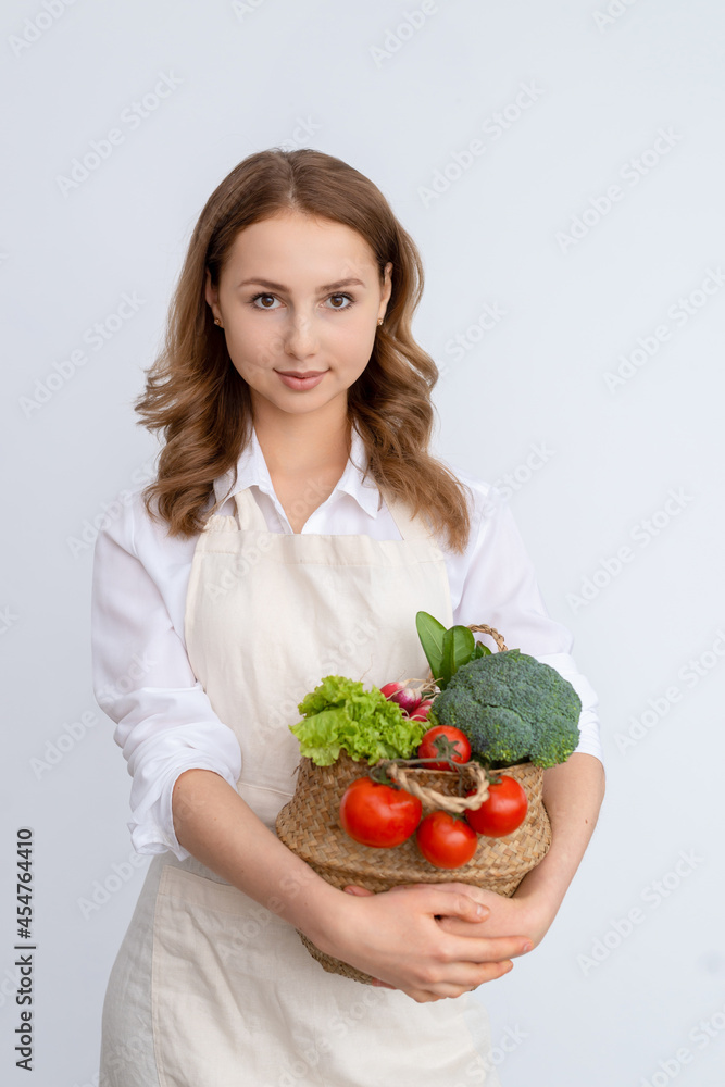 Cute girl with a basket of fresh vegetables Cute girl with a basket of fresh vegetables
