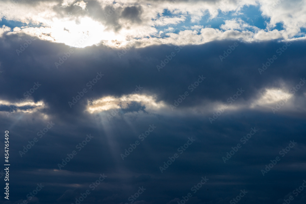 Obraz premium Rays of light shining throug dark clouds.Beautiful dramatic sky with sun rays.