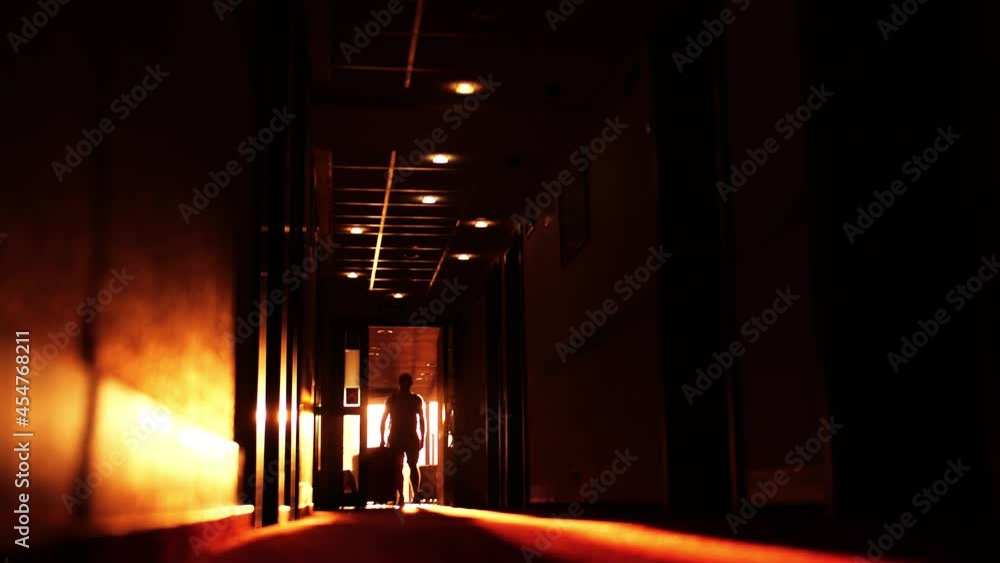 Unknown male tourist with big suitcase arrives in a hotel, slow motion shot. Summer vacation concept Unknown male tourist with big suitcase arrives in a hotel, slow motion shot. Summer vacation concept