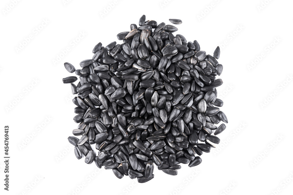 Heap of black sunflower seeds close-up on a white background with copy space Heap of black sunflower seeds close-up on a white background with copy space