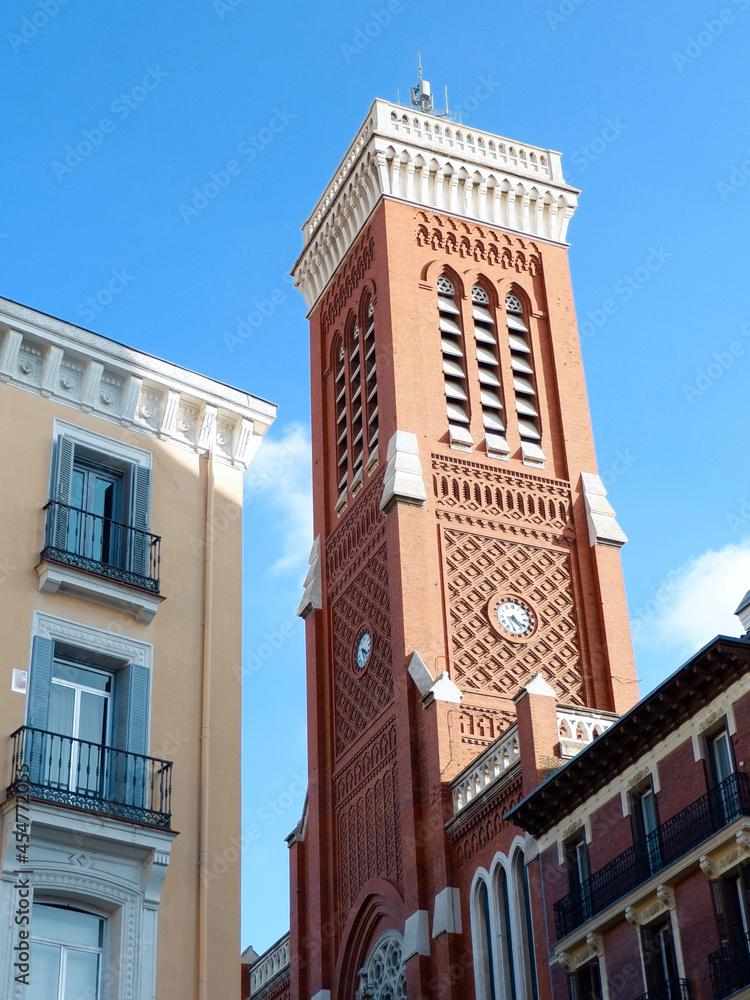 Elegant lines of classical buildings in the touristic part downtown Madrid, Spain. Classy colourful Spanish facades. Tower of Church of Saint Cross. Vertical photo Elegant lines of classical buildings in the touristic part downtown Madrid, Spain. Classy colourful Spanish facades. Tower of Church of Saint Cross. Vertical photo