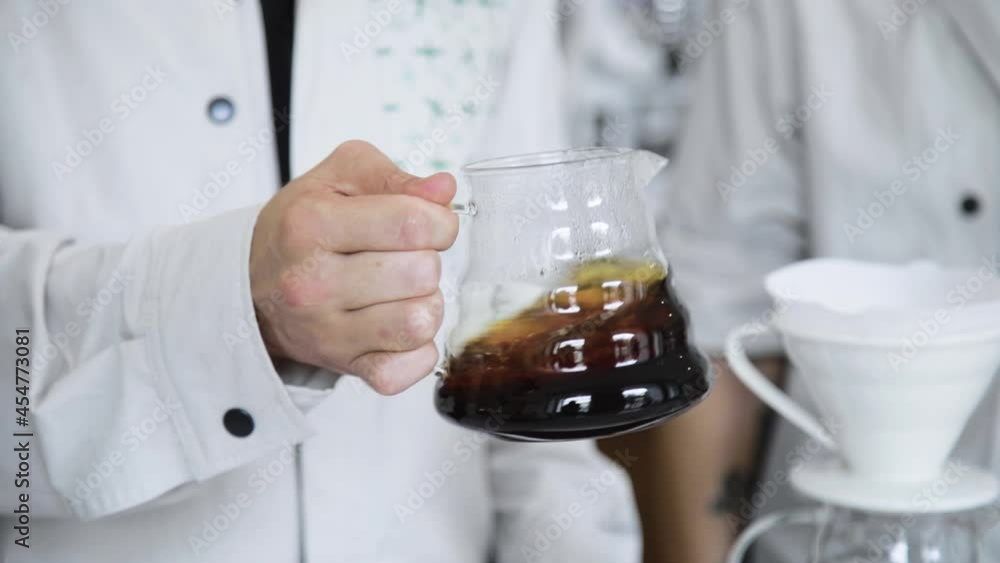 Barista making coffee. Man pours boiling water into the filter with ground coffee. Barista making coffee. Man pours boiling water into the filter with ground coffee.