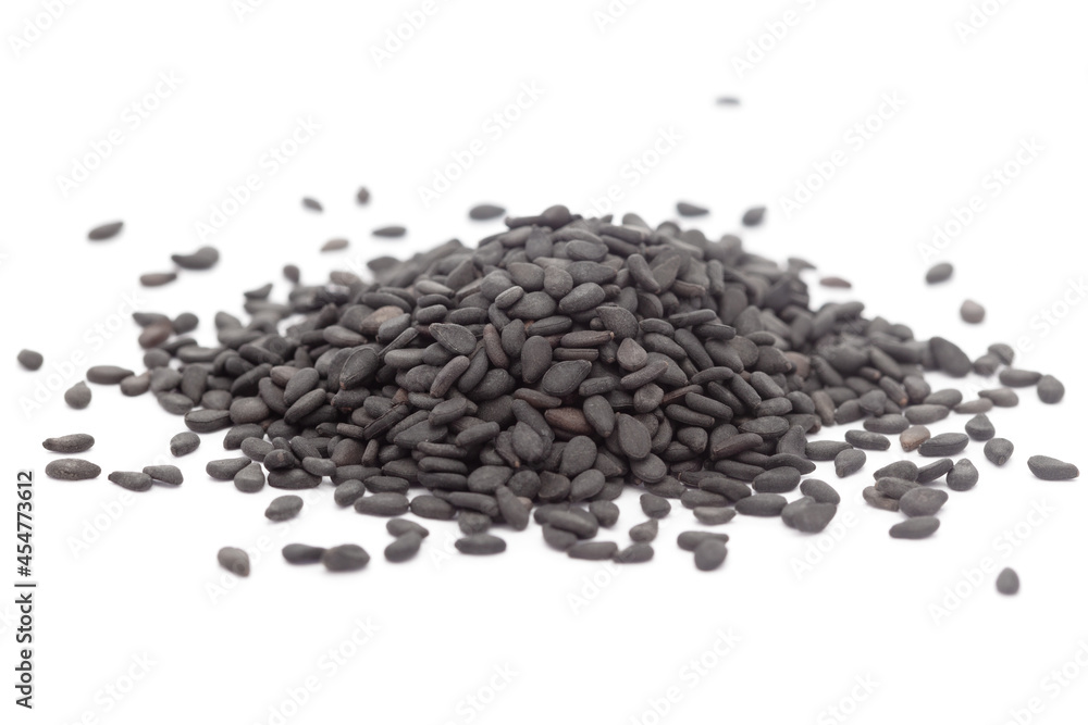 Micro close-up and details of Organic Indian Sesame seeds (Sesamum indicum) or Black Til with black shell isolated over white background. Micro close-up and details of Organic Indian Sesame seeds (Sesamum indicum) or Black Til with black shell isolated over white background.